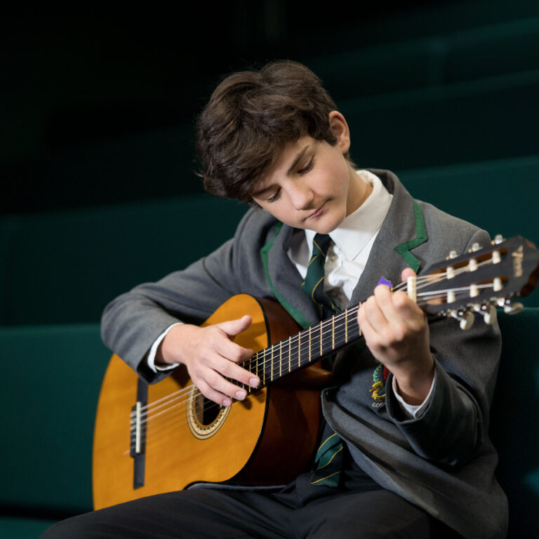 boy playing the guitar